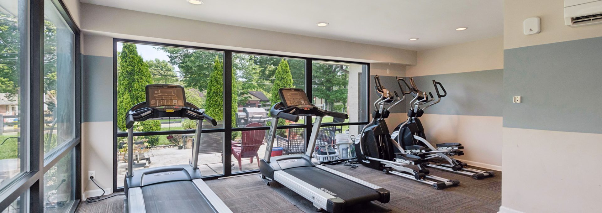 a room with two couches and a large window